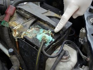 Corrosion build-up on a car battery terminal