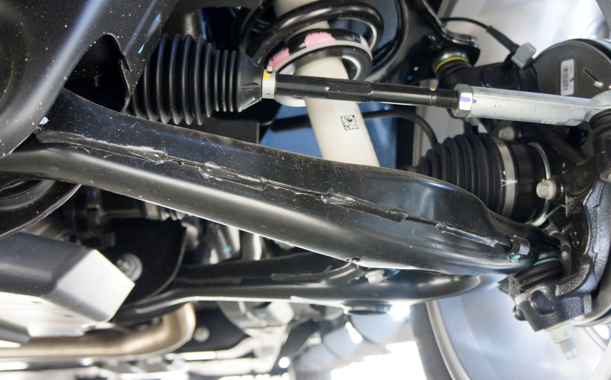 control-arm-repair-hamilton Control arm and bushing being inspected