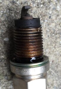 Dirty spark plugs are a common symptoms of a rich air/fuel mixture.
