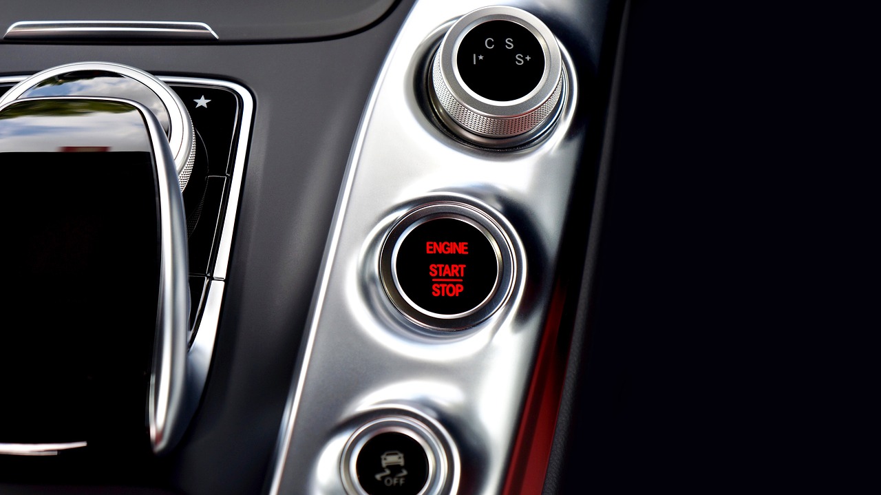 car-2498289_1280 Engine start stop button glowing red on a car centre console