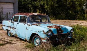 Old rusty car parked and unwarranted
