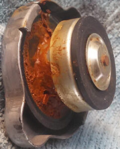 Heavily rusted radiator cap and corroded filler neck