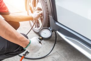 Checking tyre pressure with a gauge