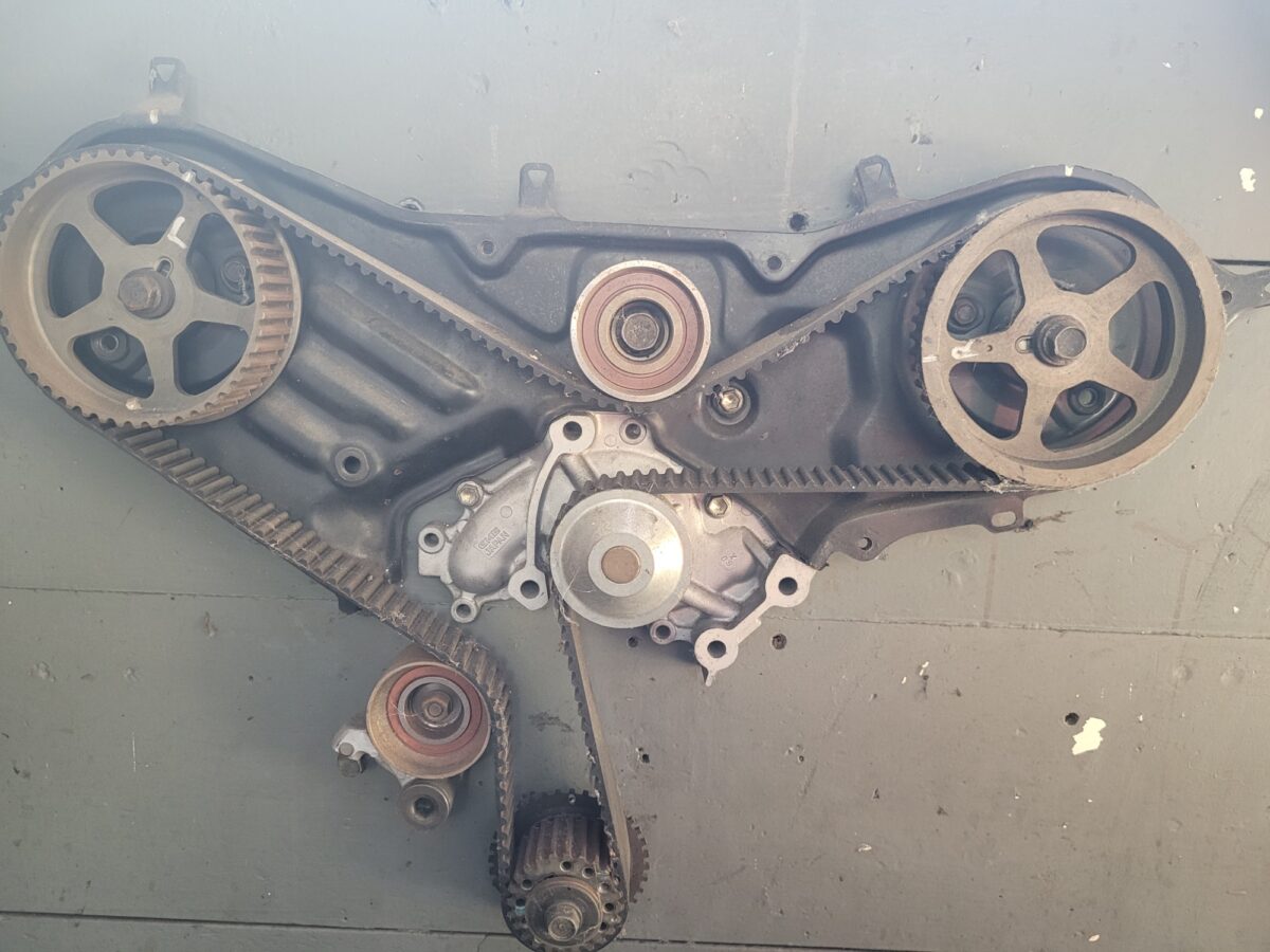 Engine timing belt and pulleys, showing the mechanical components. Engine timing belt and pulleys, showing the mechanical components.