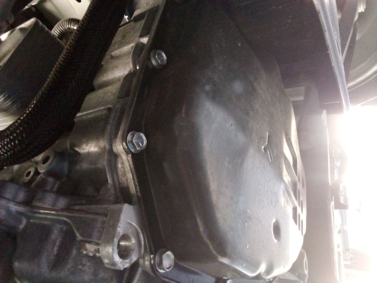 Transmission pan bolted to underside of vehicle, ready for fluid change