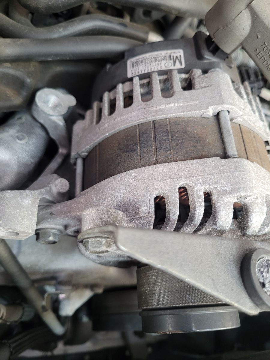 Close-up of Car Alternator Detailed view of a car alternator mounted in an engine bay