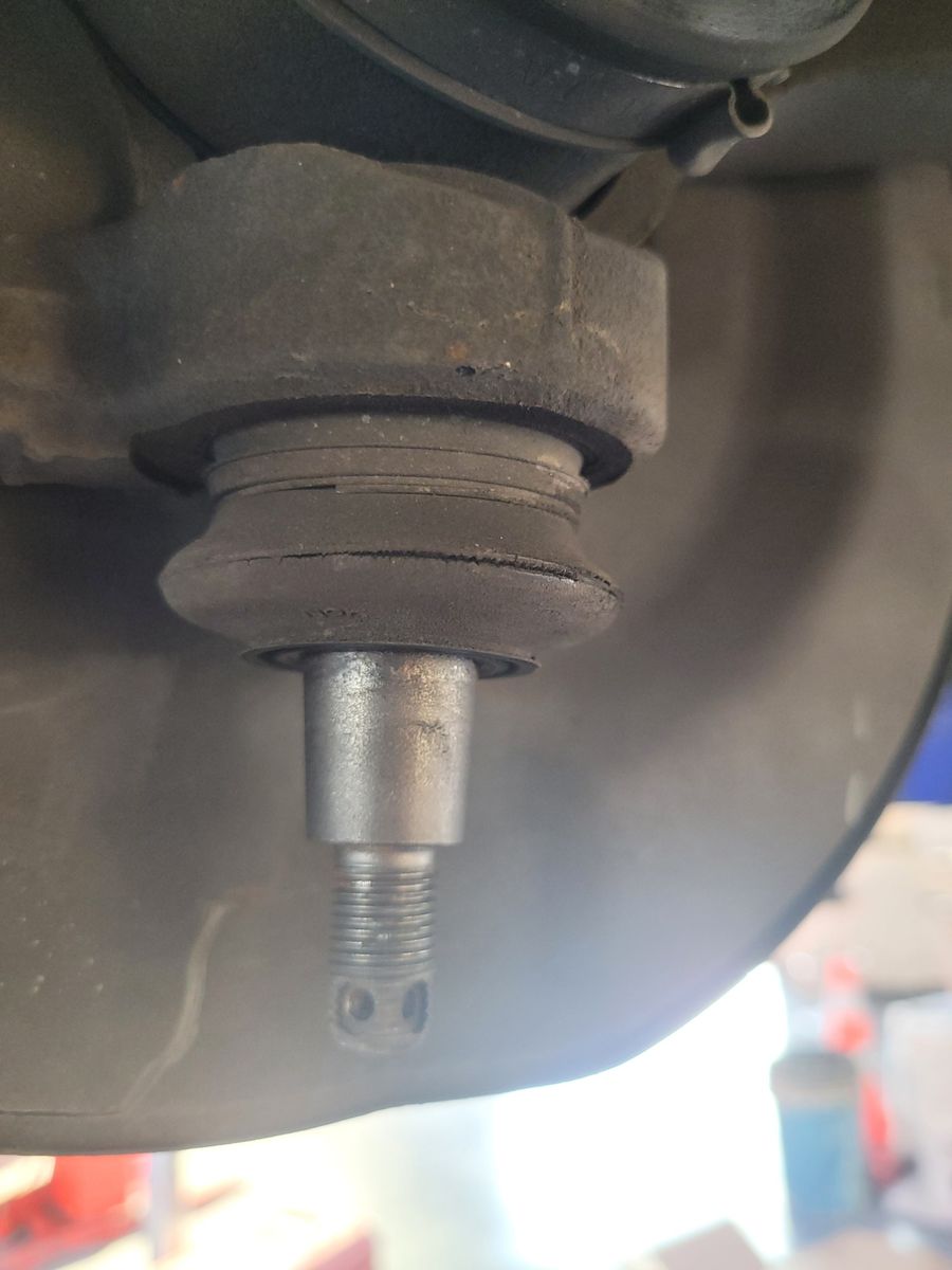 Close-Up View of a Car Ball Joint A vehicle suspension ball joint showing the threaded stud and rubber boot.