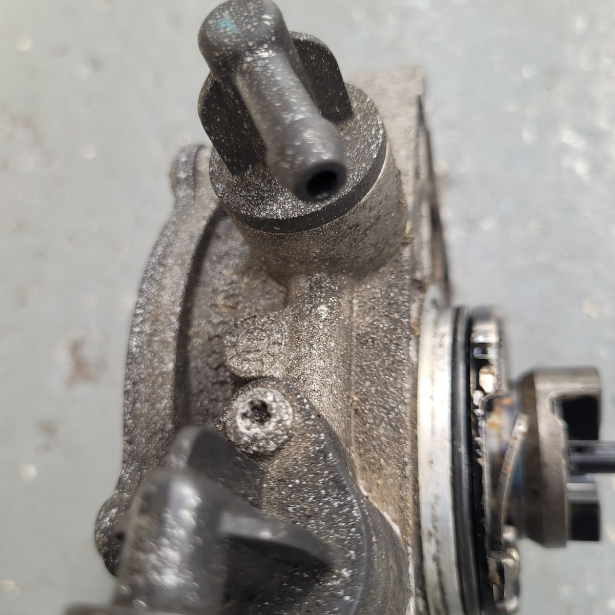 Close-Up of Worn Brake Vacuum Pump Component Detailed view of a dusty brake vacuum pump showing connectors and seal.