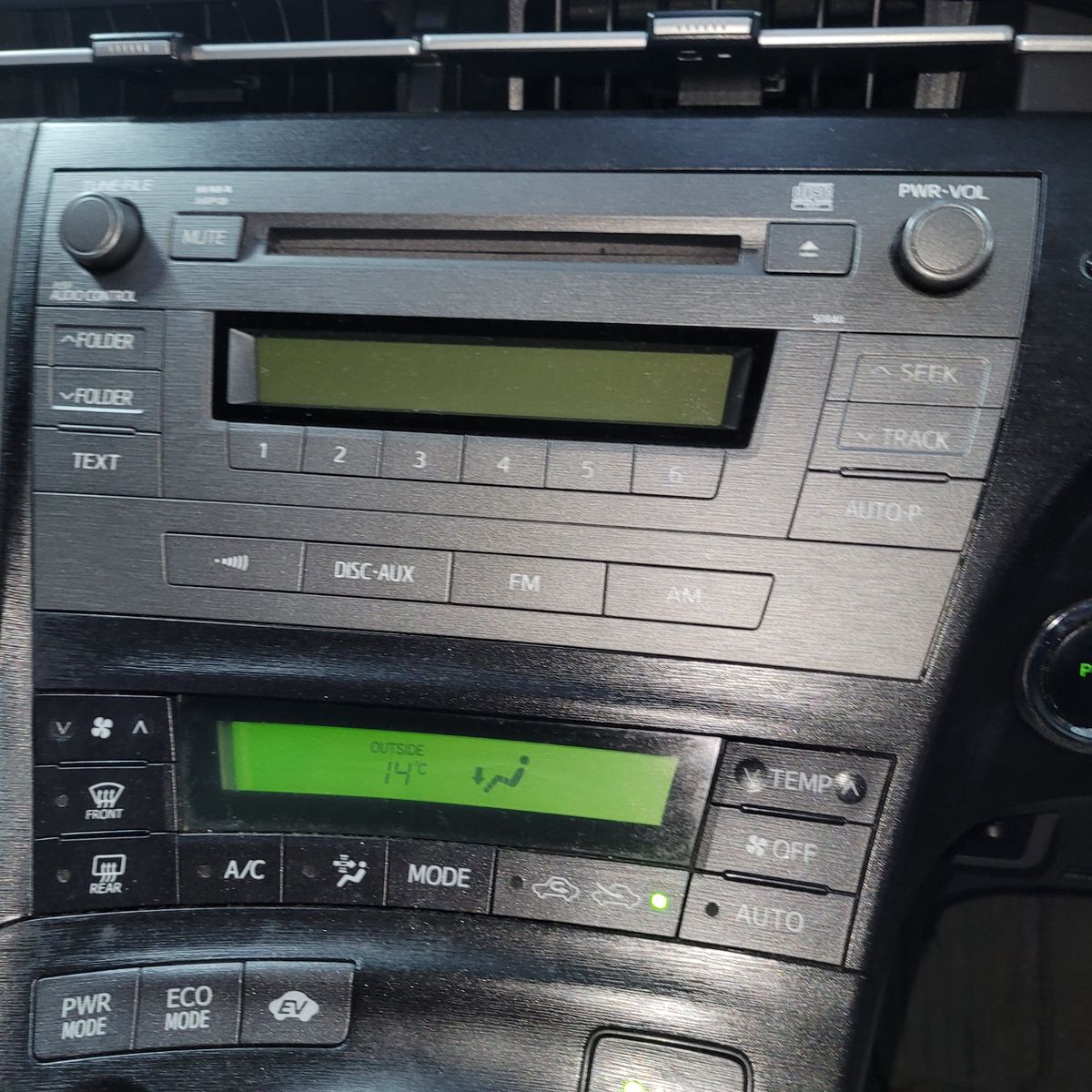 Car radio and climate control panel with buttons and display screens