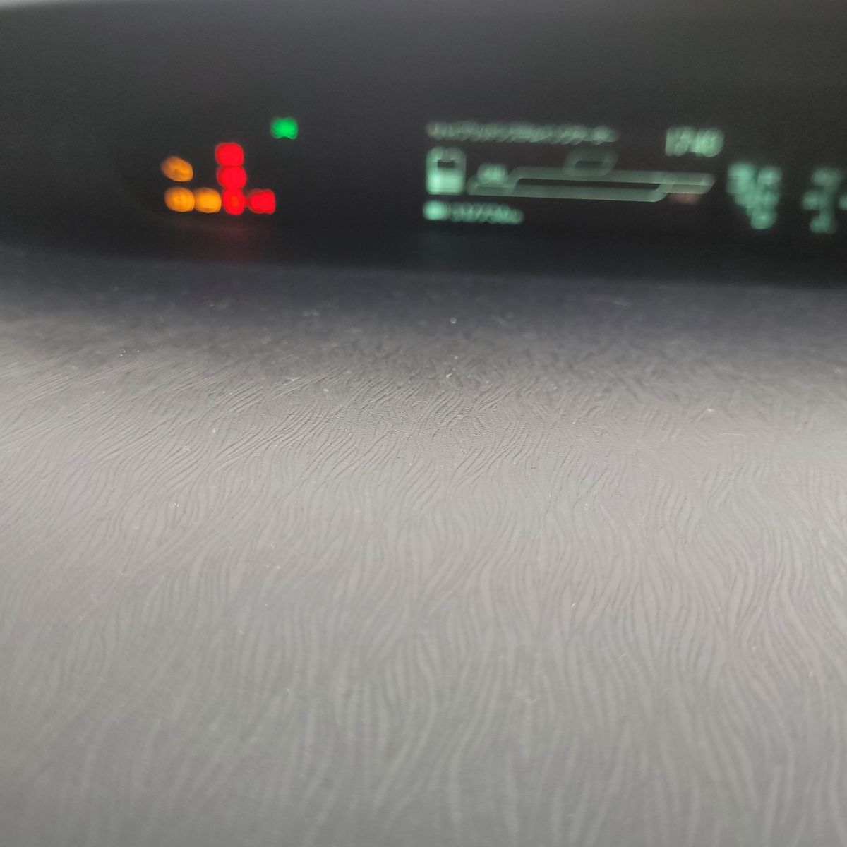 Car Dashboard Warning Lights Blurry dashboard shows illuminated red and amber warning lights.