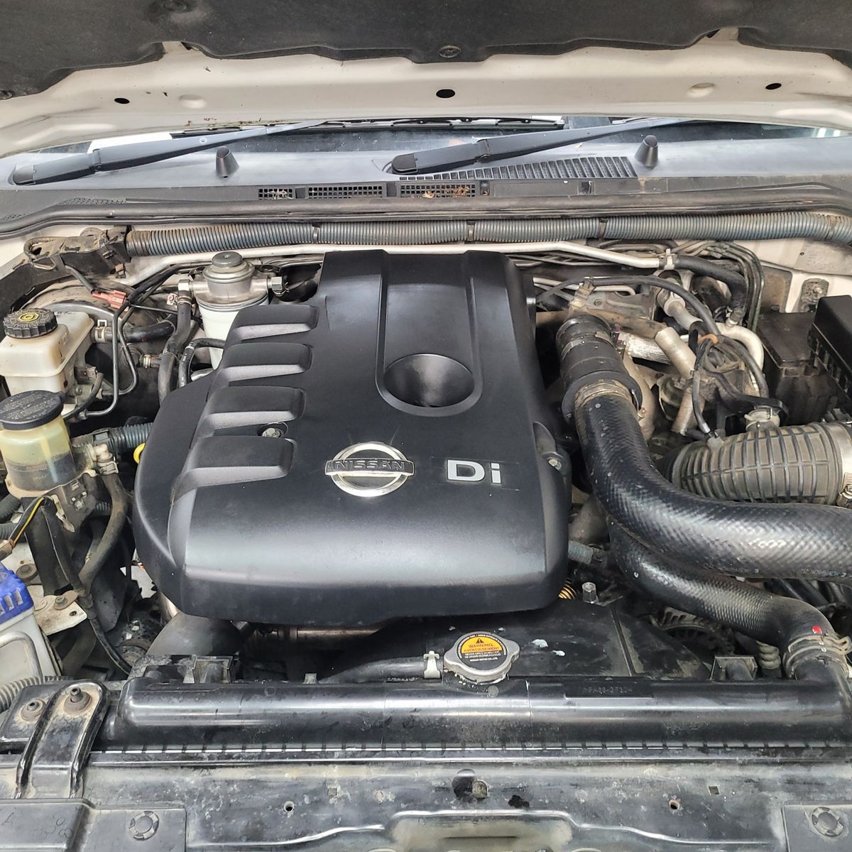 Nissan Diesel Engine Compartment View of a Nissan diesel engine under the hood of a vehicle.