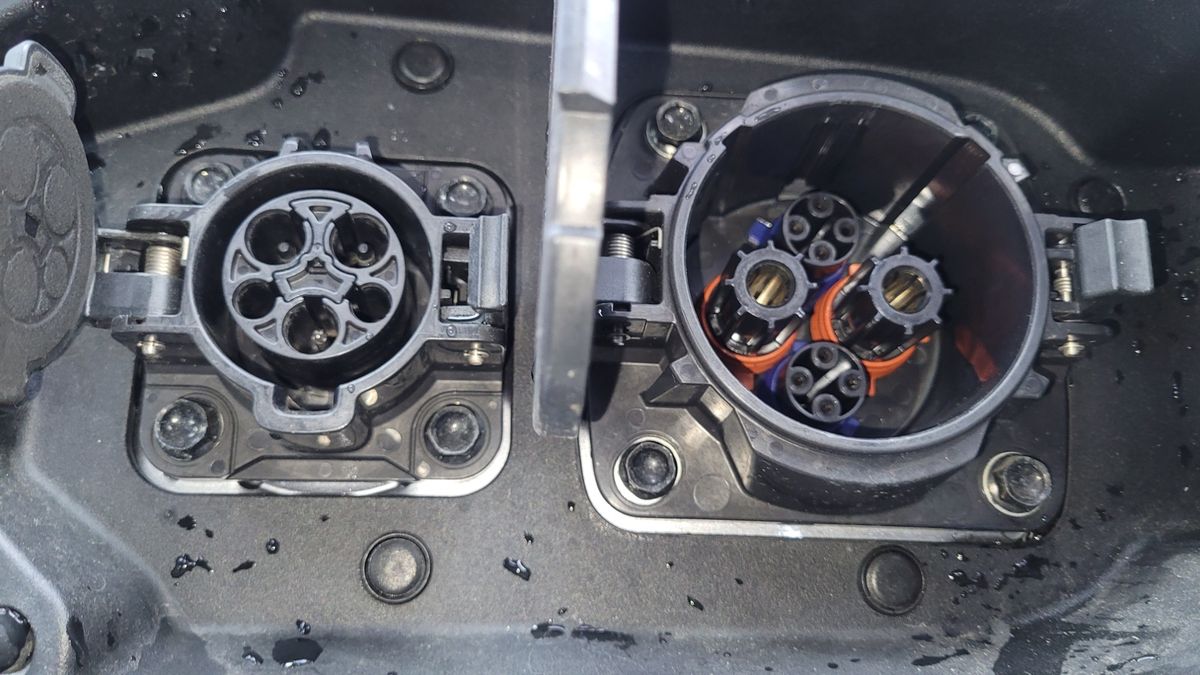 Dual electric vehicle charging ports close-up Close-up of two electric vehicle charging ports with open covers