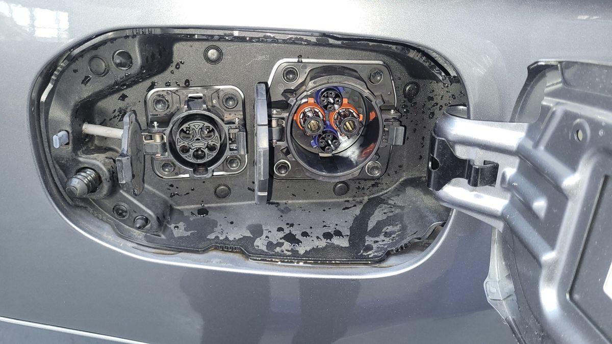 Close-up view of an electric vehicle charging port with two connector types.
