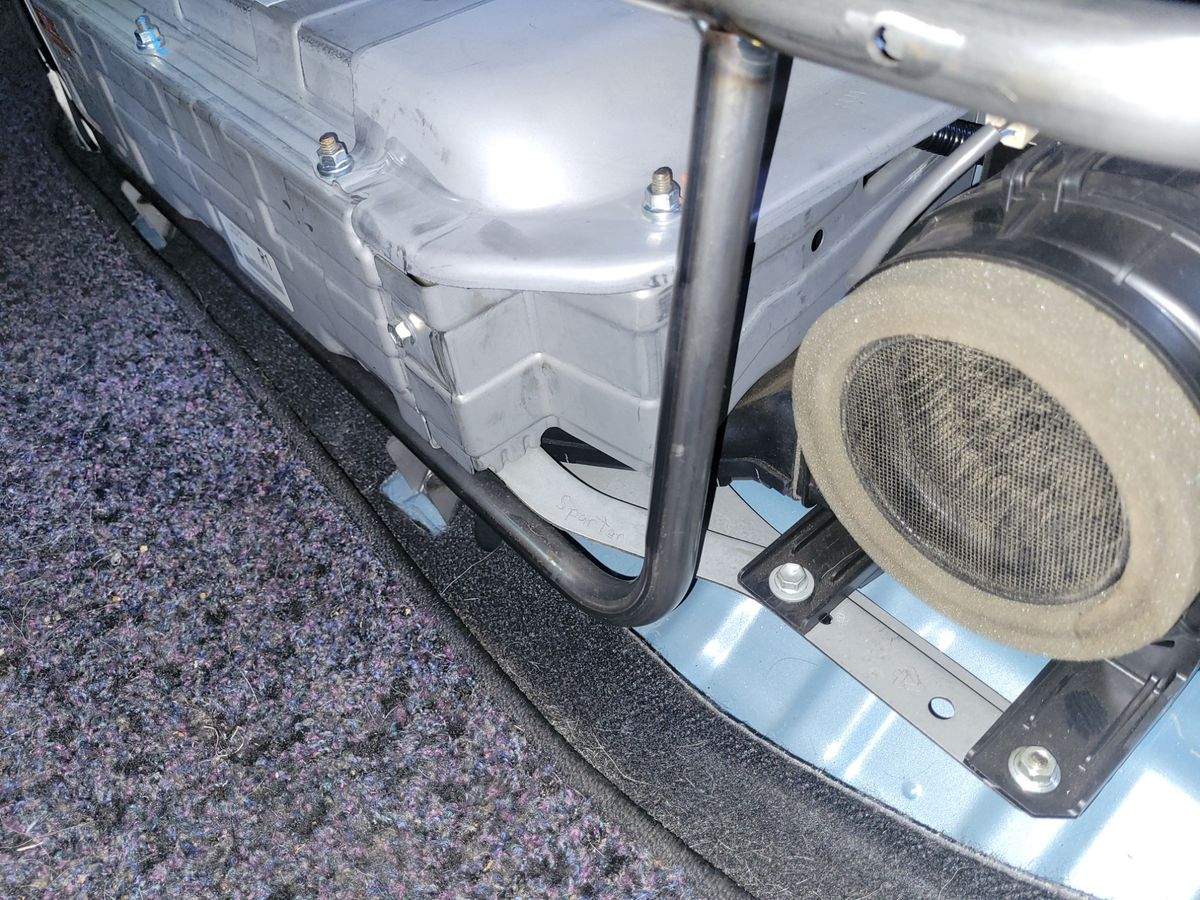 Close-Up of Hybrid Car Battery Compartment Hybrid car battery pack with protective casing and cooling vent visible