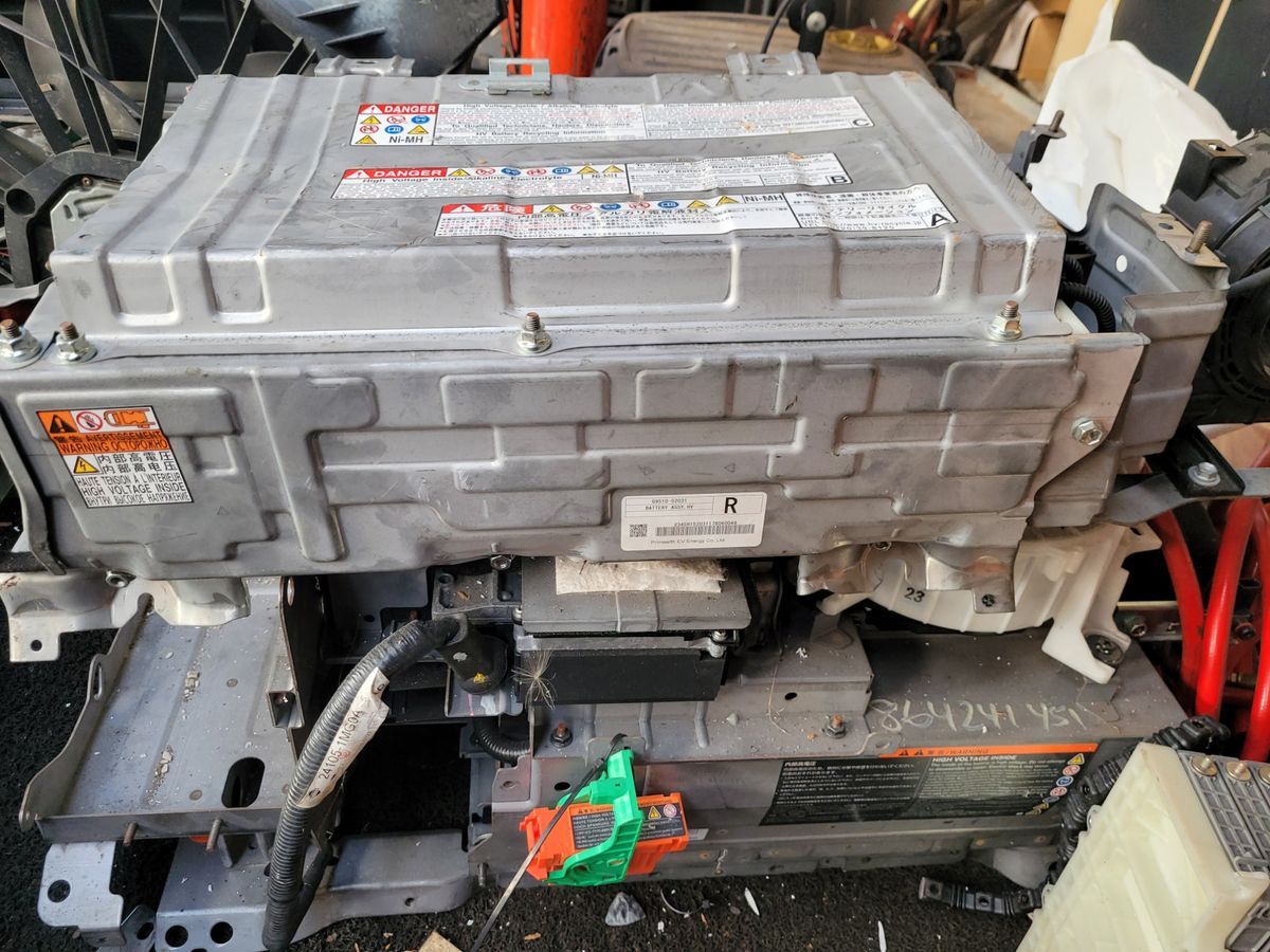 Large metallic hybrid battery pack with warning labels and electrical connectors