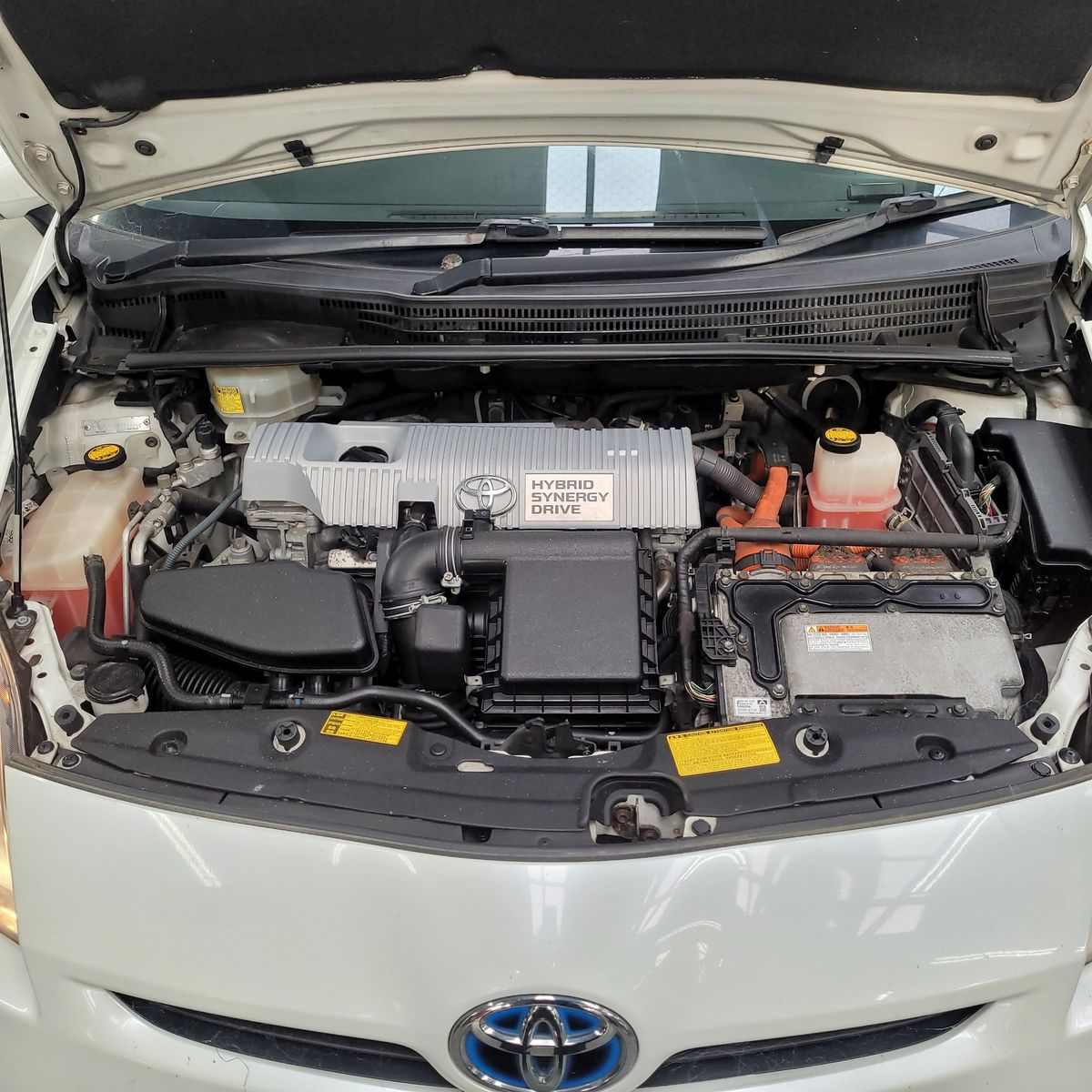 Open hood revealing Toyota hybrid engine with Hybrid Synergy Drive system