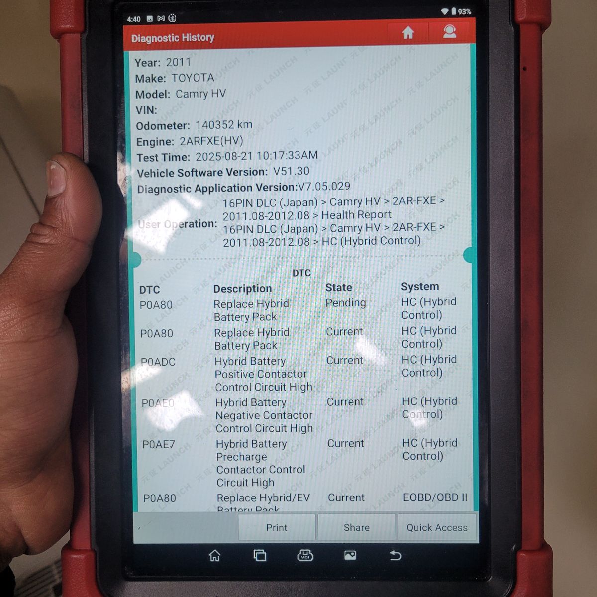 Close-up of a handheld diagnostic scanner showing hybrid battery faults for a Toyota Camry HV.