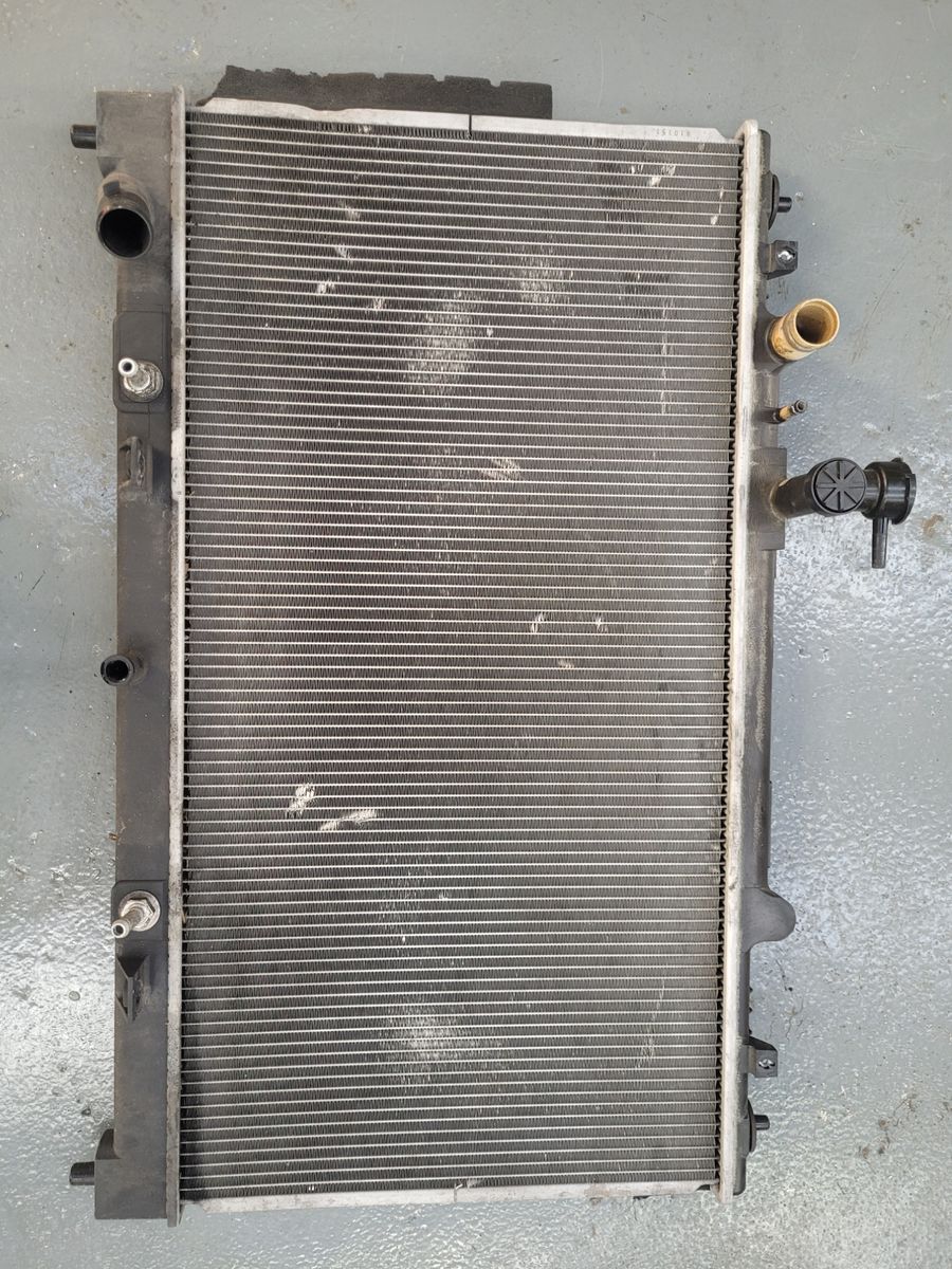 Car Radiator on Workshop Floor Used car radiator lying flat on a concrete floor