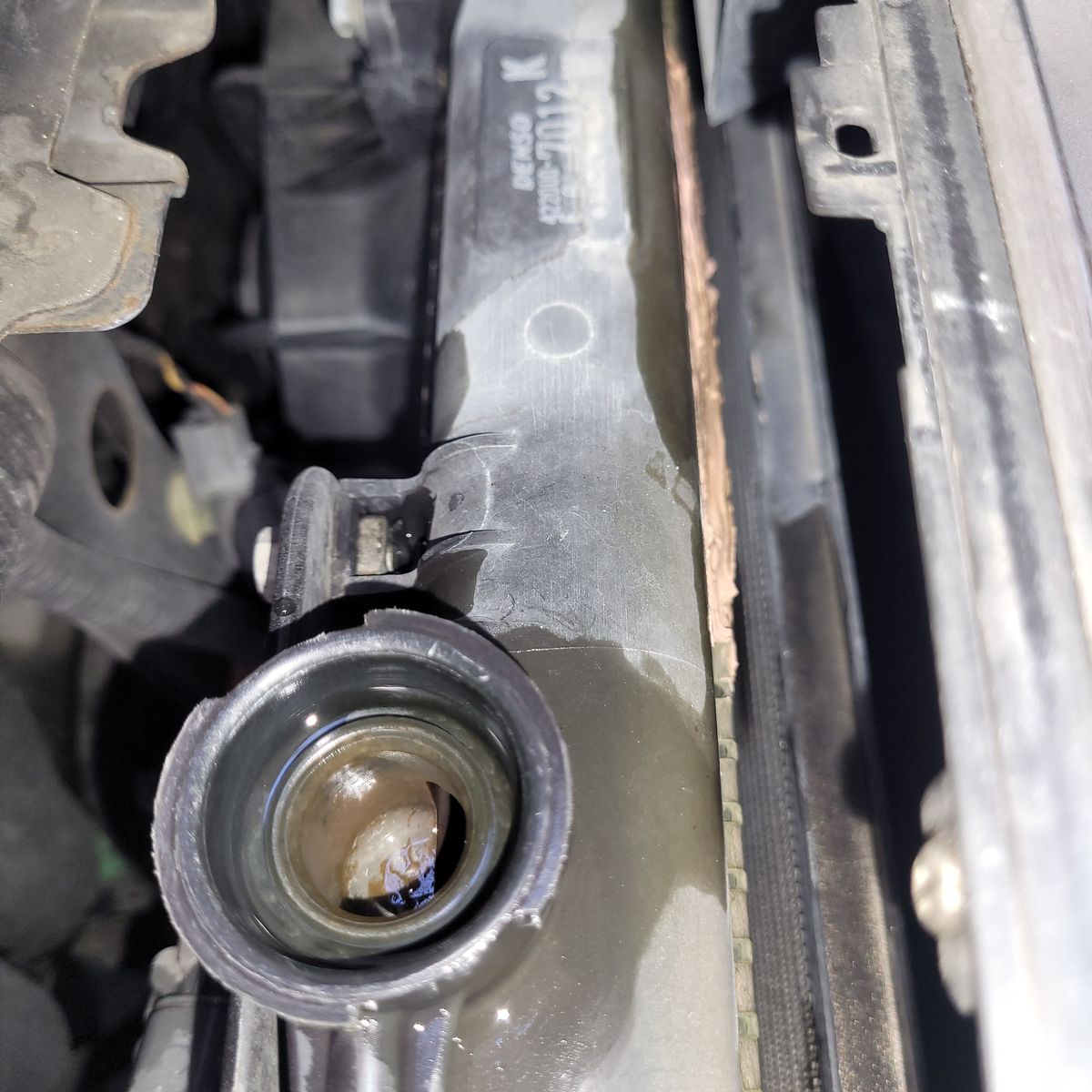 Open Car Radiator Filler Neck Closeup Open car radiator with visible filler neck and coolant inside.