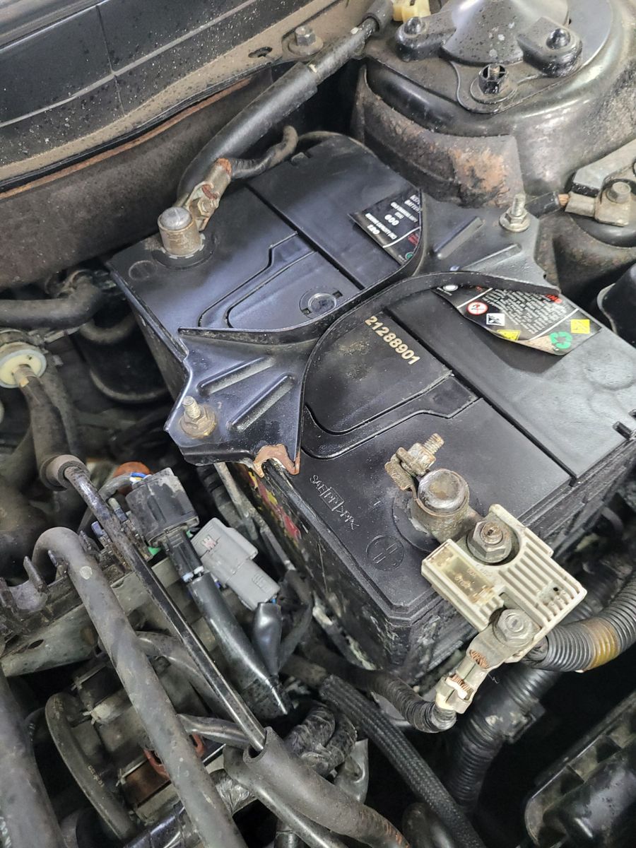 Close-up of a 12-volt car battery installed in an engine bay