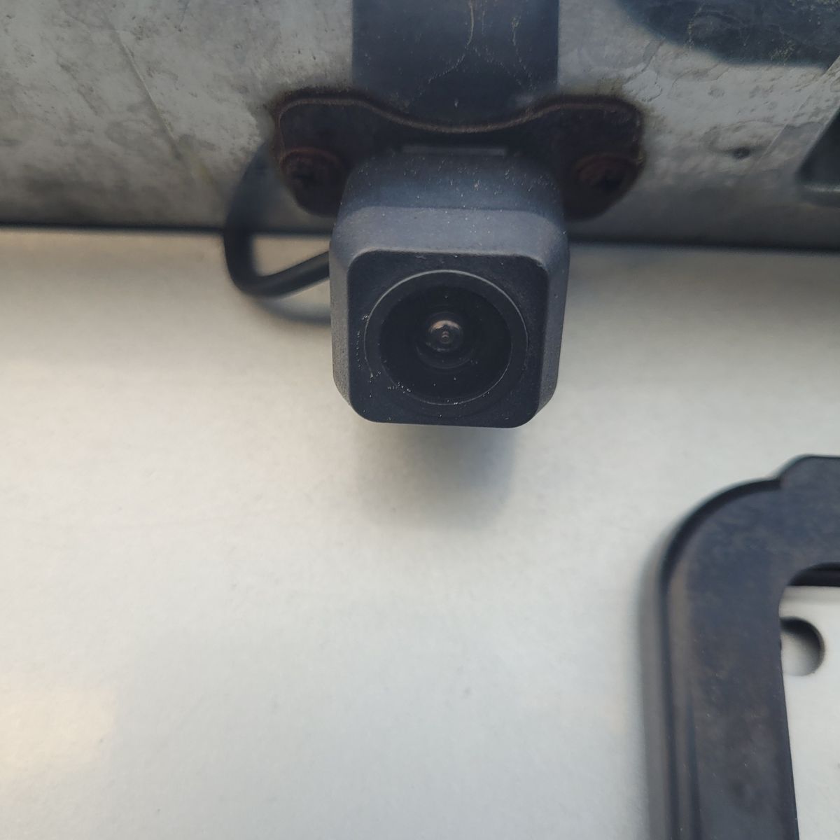 Close-Up of a Car Reversing Camera Square reversing camera mounted on a car near license plate area