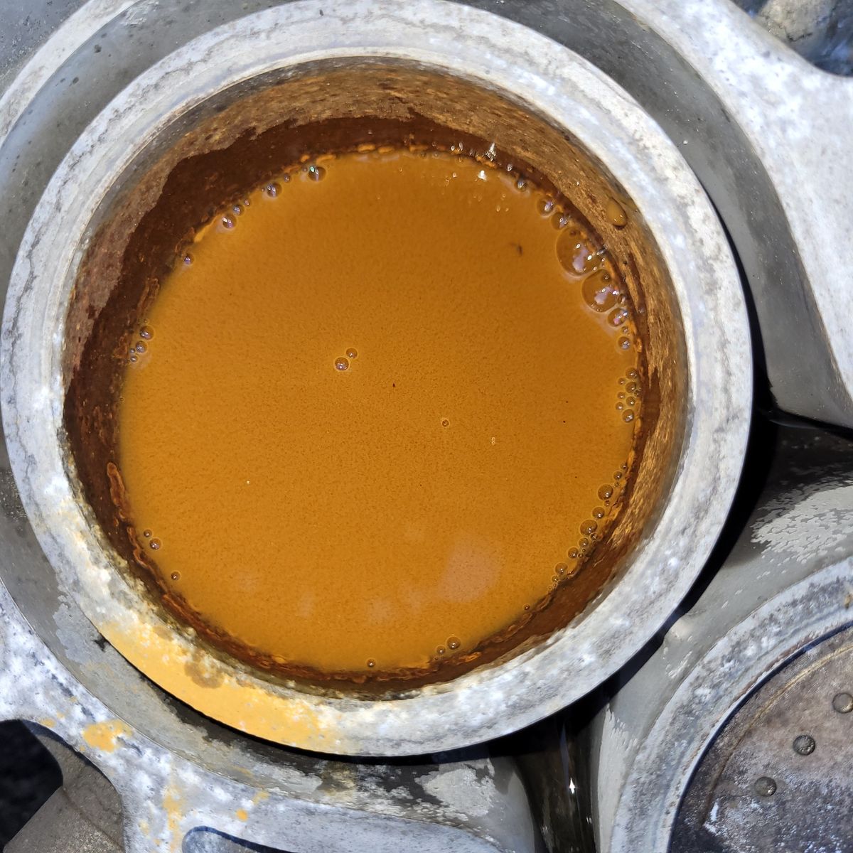 Rusty Water in Engine Radiator Close-up of radiator filled with orange-brown rusty water