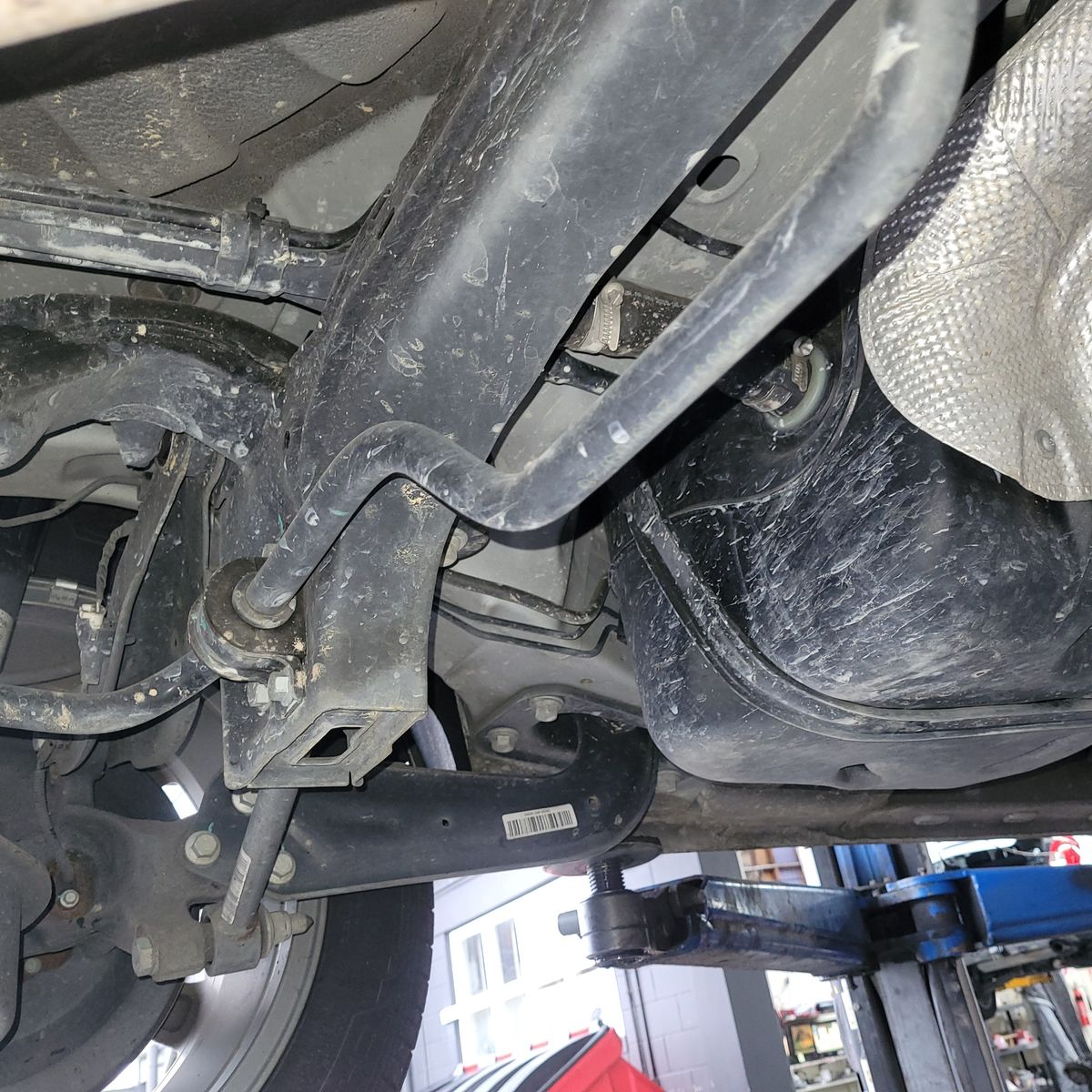 Close-up of a car's sway bar and suspension components underneath the chassis