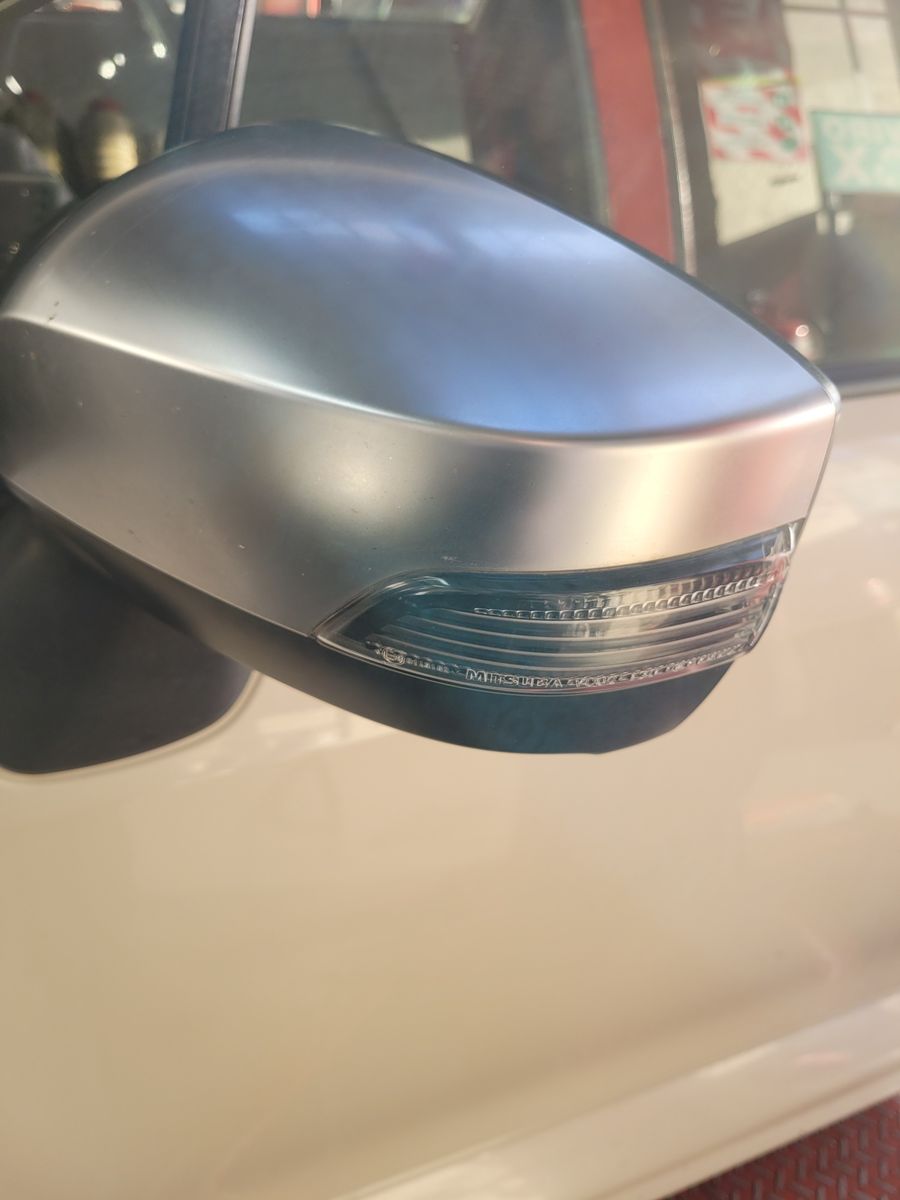Close-Up of a Car Wing Mirror with Turn Signal Light Silver car wing mirror with integrated turn signal light